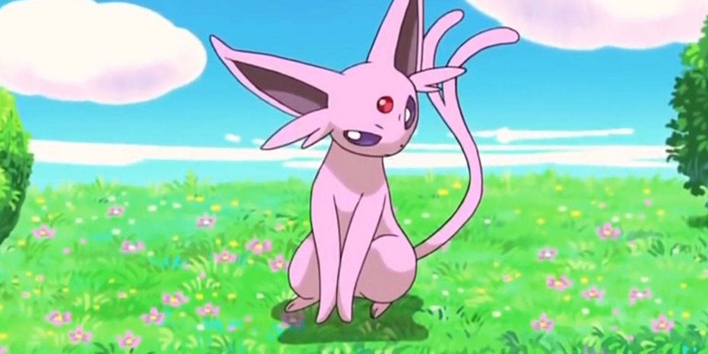 Espeon from the Pokemon anime sitting in a field.