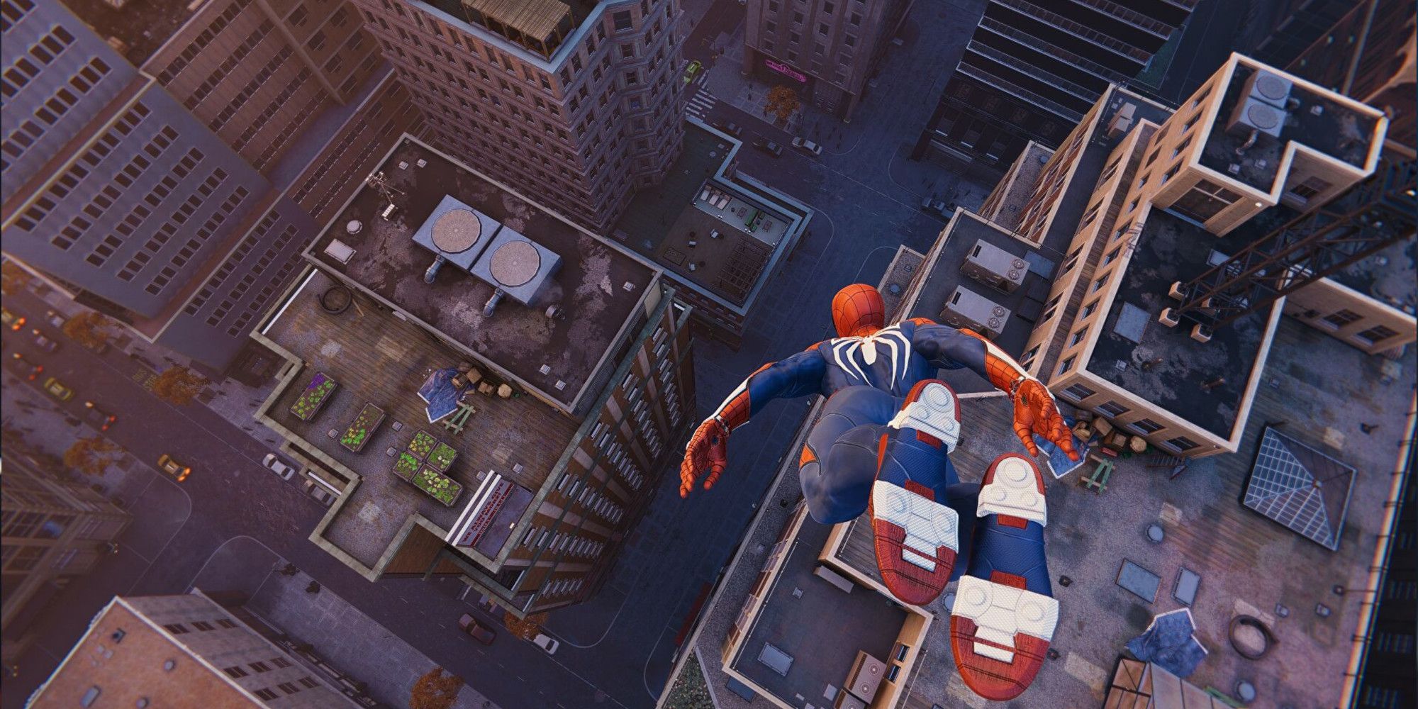 Spider-Man diving towards a sea of buildings in New York city.