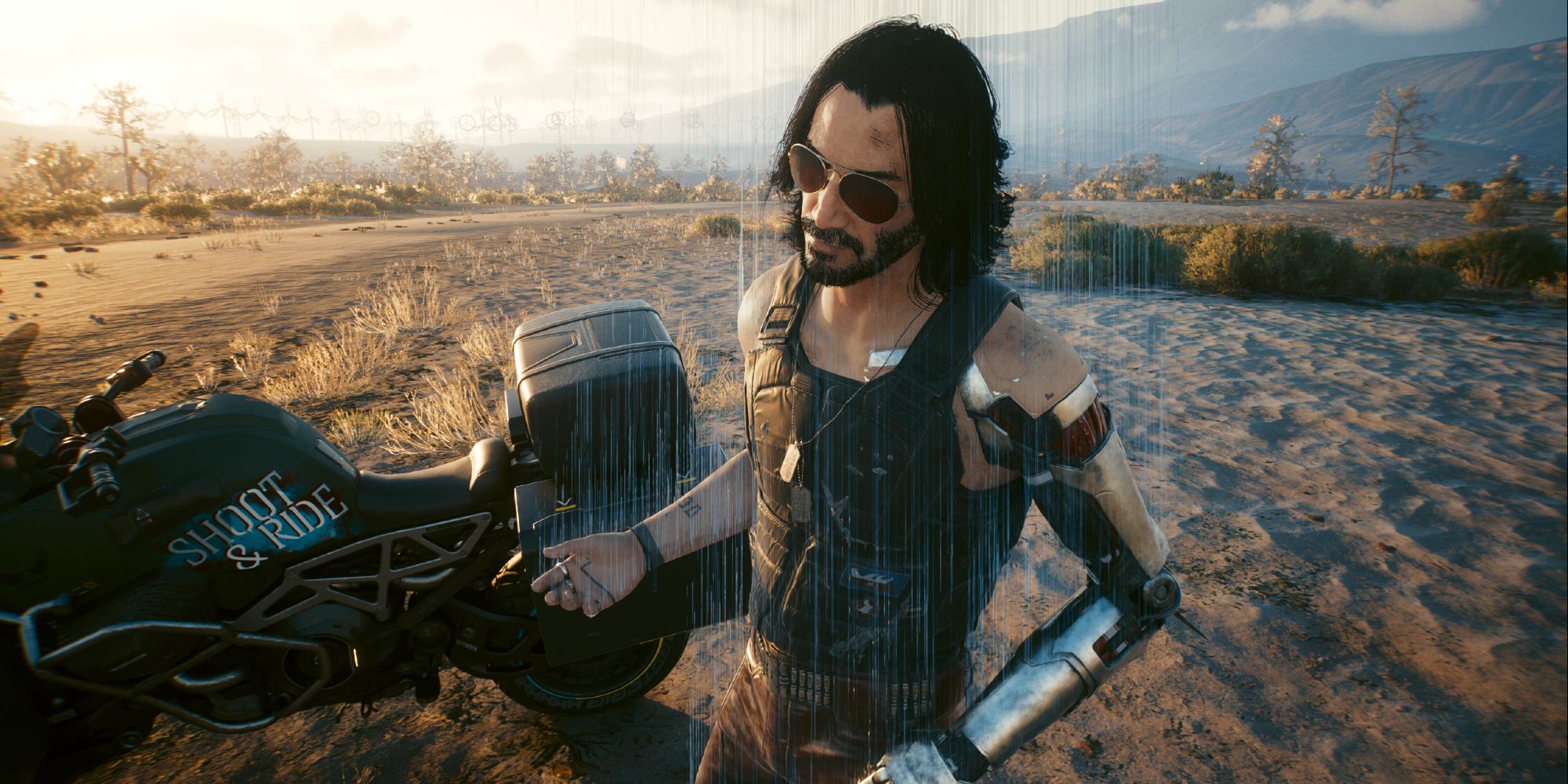Johnny Silverhand besides a bike in the badlands in Cyberpunk 2077.