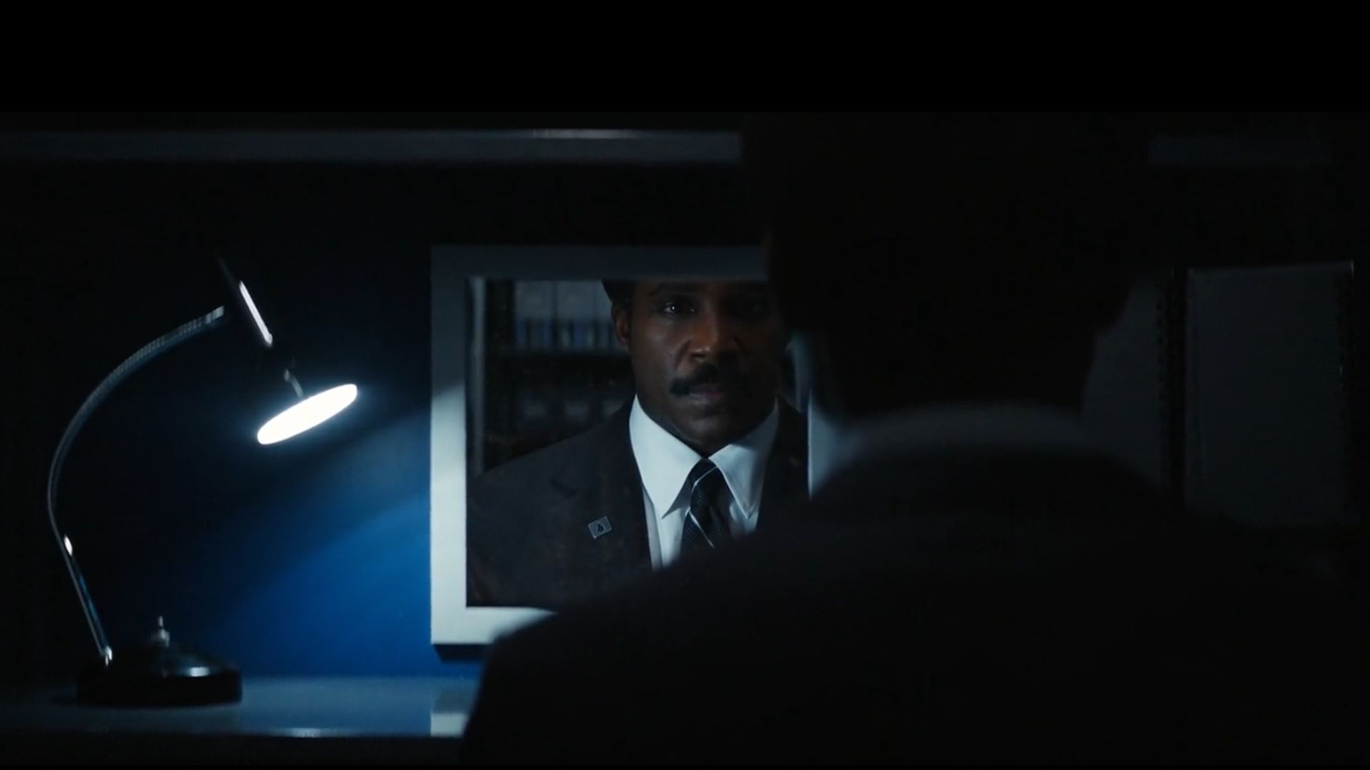 Milchick In Front Of A Mirror In Atilla From Severance.