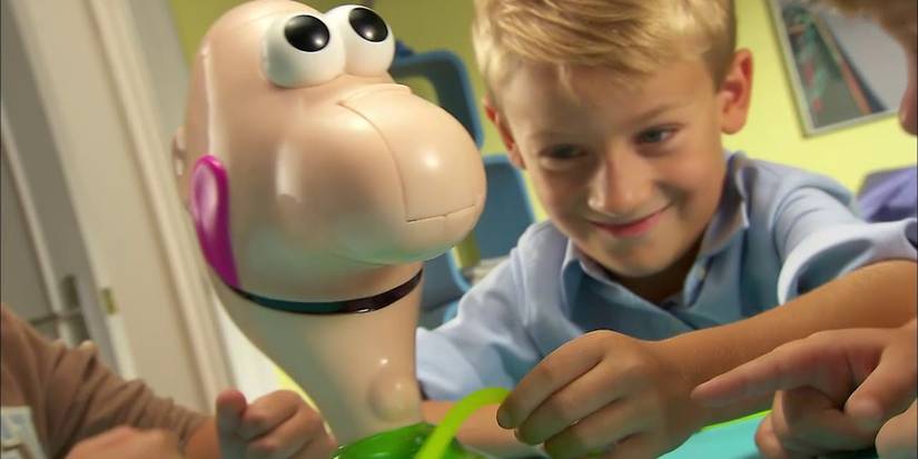 Gooey Louie board game kid playing game plastic Louie figure