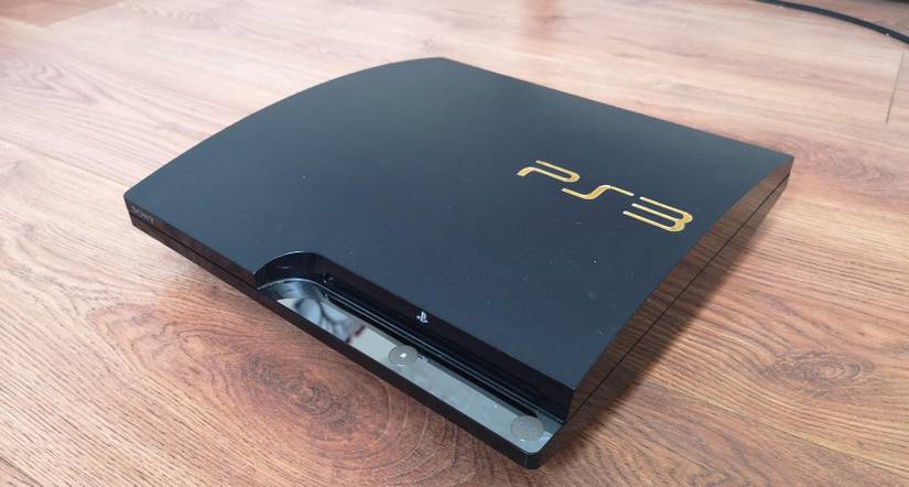 PS3 slim on a wood floor