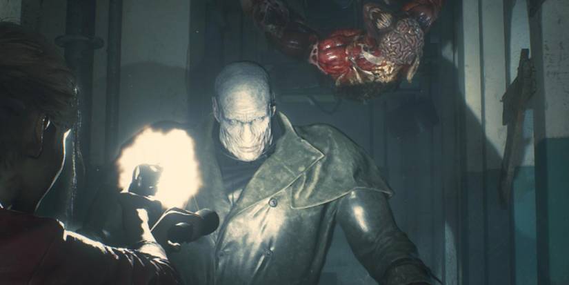 Claire fires her pistol at Mr. X with a flashlight, as a licorice slides up from the ceiling.