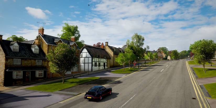 Forza Horizon 4 Broadway location with car driving down road near village
