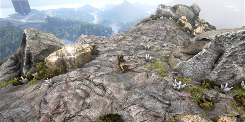 player on mountain top with crystal