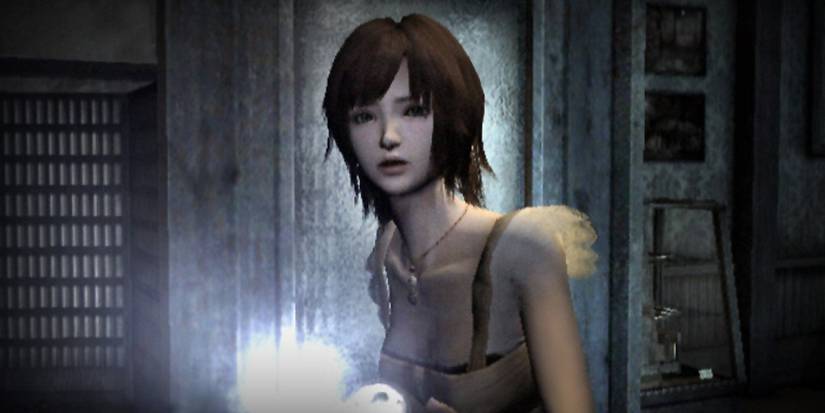 Fatal Frame 4 protagonist hunched over with a flashlight