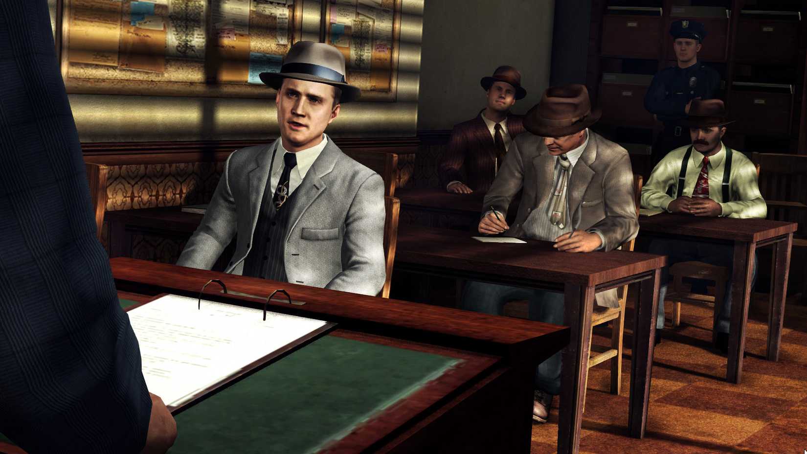 Cole Phelps at a table with various detectives behind him in LA Noire.