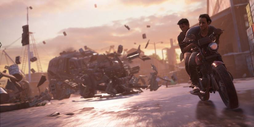 A screenshot showing Sully and Nate being chased by a tank in Uncharted 4: A Thief's End