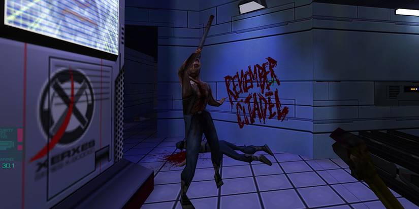 In-game screenshot System Shock 2, an enemy attacking with a melee weapon while a body is lying on the floor behind them.