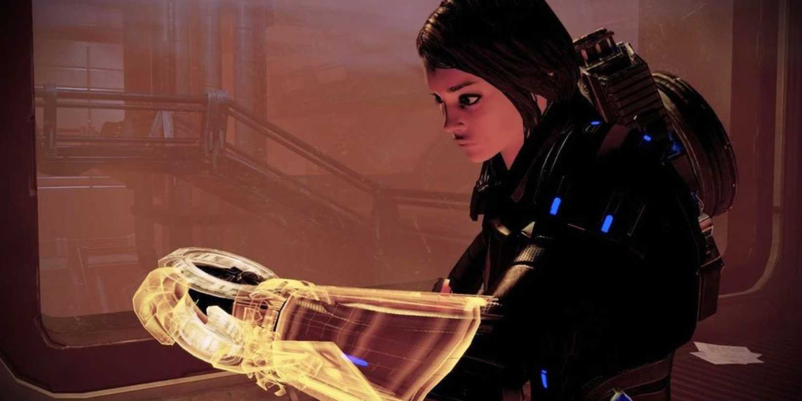 Mass Effect 2 screenshot of a female Shepard using her omni tool