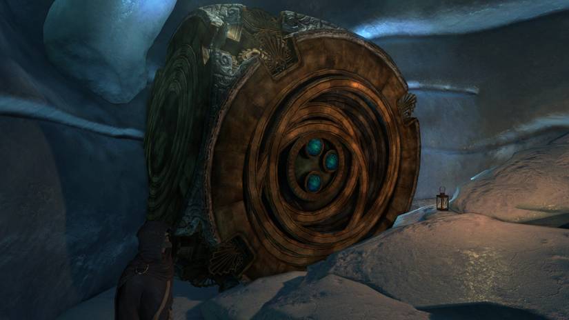 A large burnished gold puzzle box sits inside an icy cave