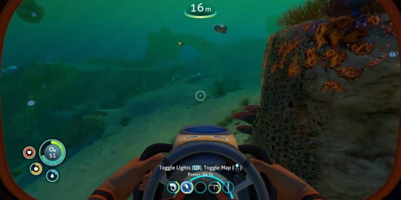 The player swimming around a large rock with the seaglide in hand