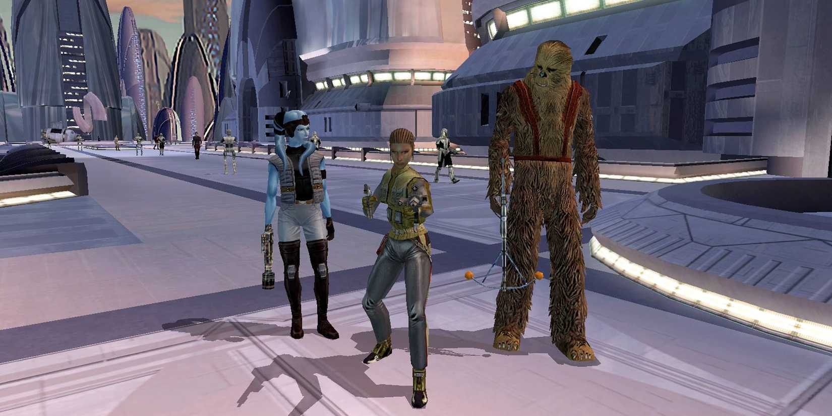 A blue alien, a Wookie and a female human stands in a sci-fi city in Star Wars: Knights Of The Old Republic.