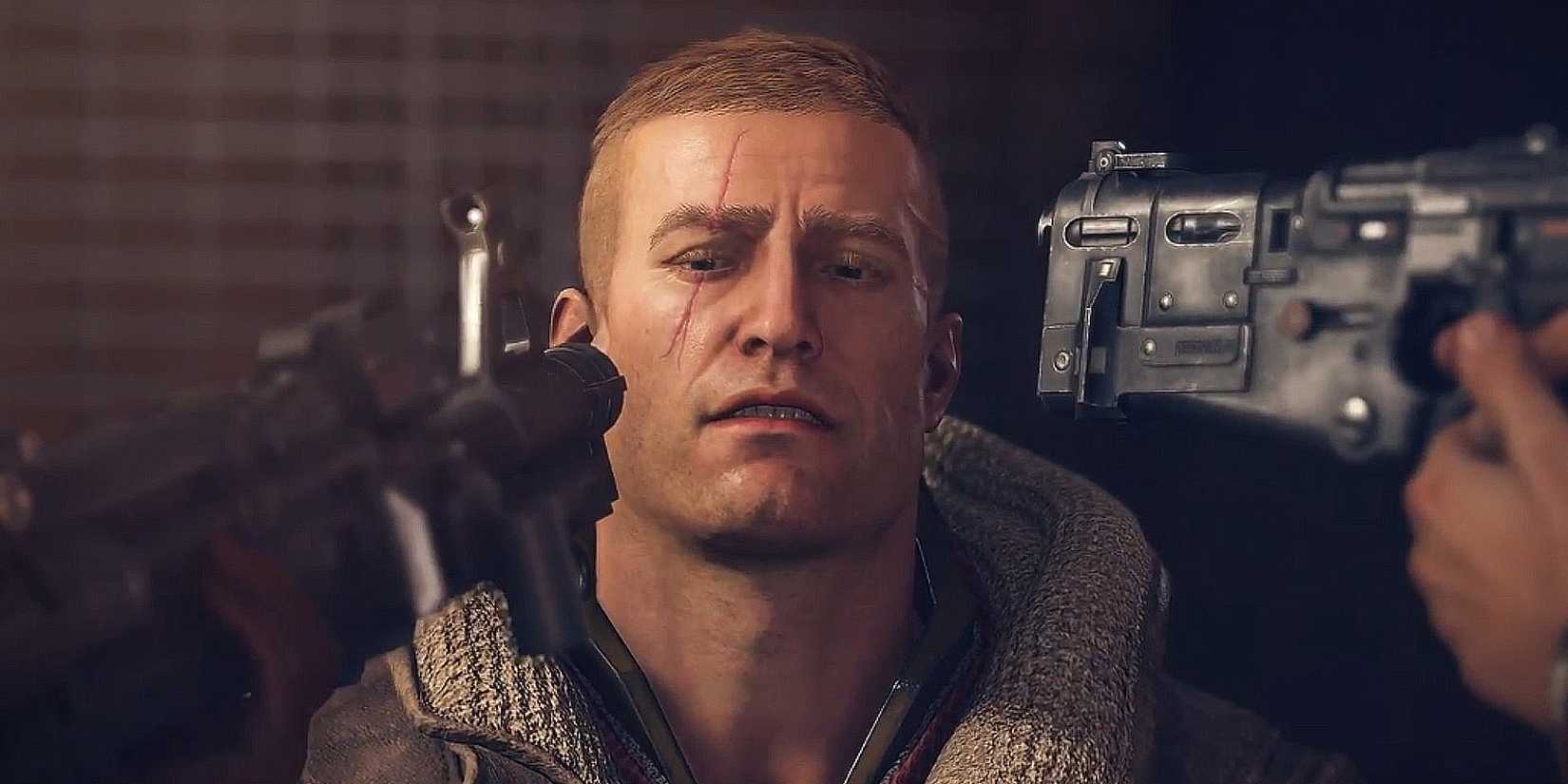BJ Blazkowicz sits as two guns are pointed at his head.