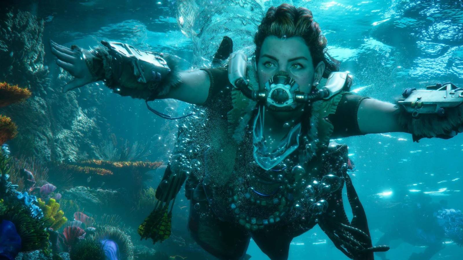 Aloy swimming past a giant reef with a breathing mask on in Forbidden West.