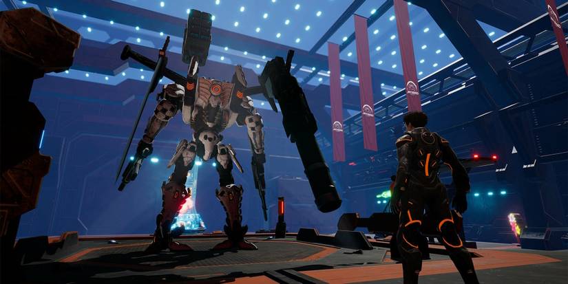 A man standing in front of an unpiloted Mecha inside a facility room.