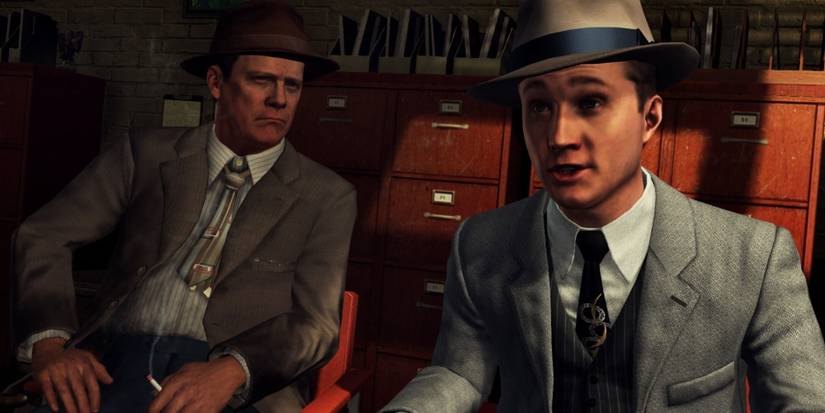 LA Noire Cole Phelps and Ralph Dunn sit together in an office.