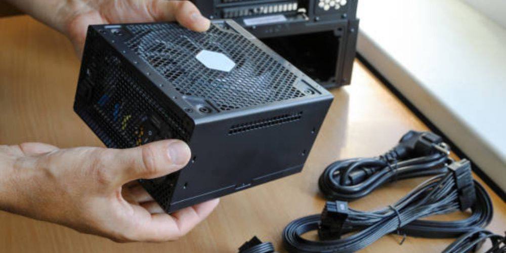 Hand holding a power supply