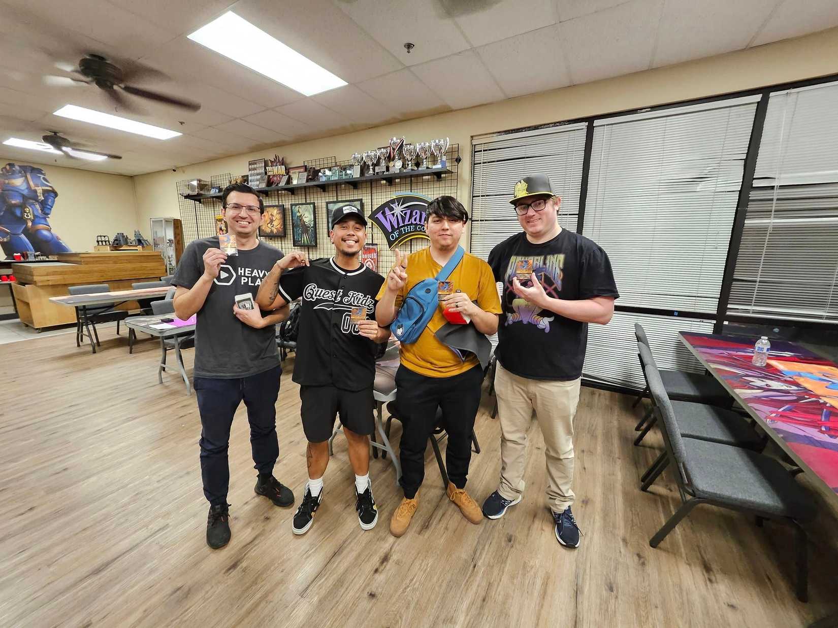 winners posing inside gmi games lorcana