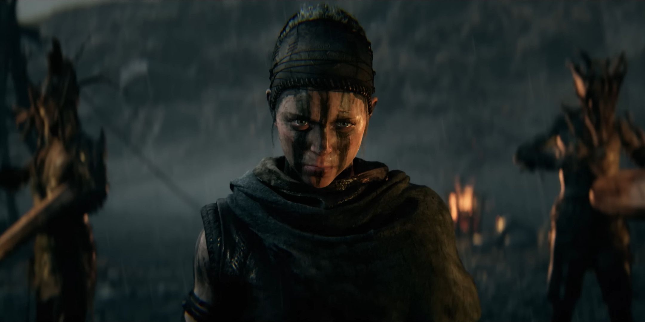 Senua and two people holding weapons in the distance in Hellblade 2