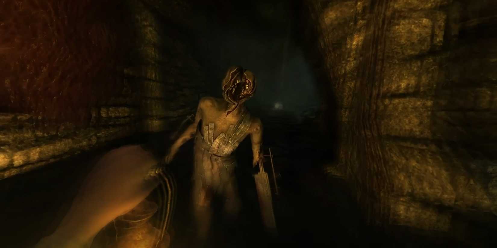 First-person view of an amnesiac monster rushing towards the camera in a dark hallway.