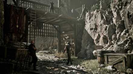 A screenshot of Gothic 1 Remake, showing a run down wooden structure in a muddy terrain, with a man watched by two people.