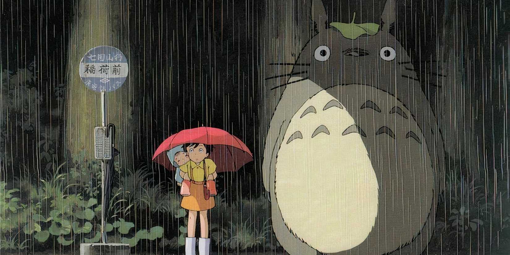 Two girls standing in the rain with Totoro from My Neighbor Totoro.