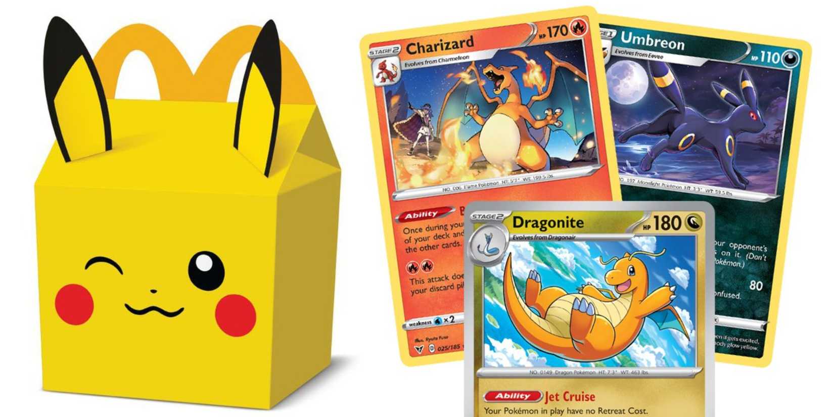 There's a Pikachu McDonald's Happy Mick box next to the Dragonite, Charizard, and Umbreon cards.