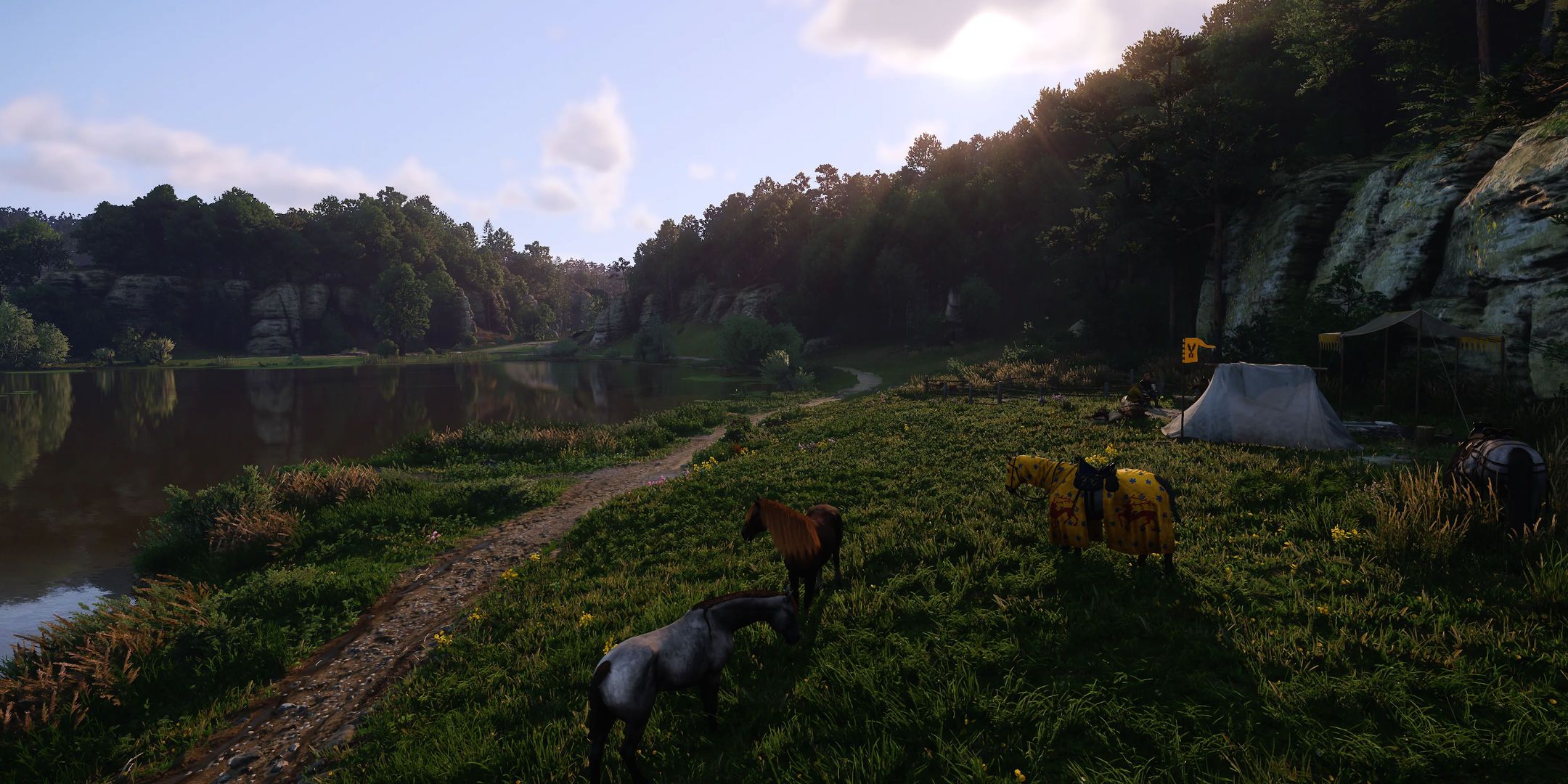 Kingdom Come: Deliverance 2 screenshot of a vista near a lake with horses.