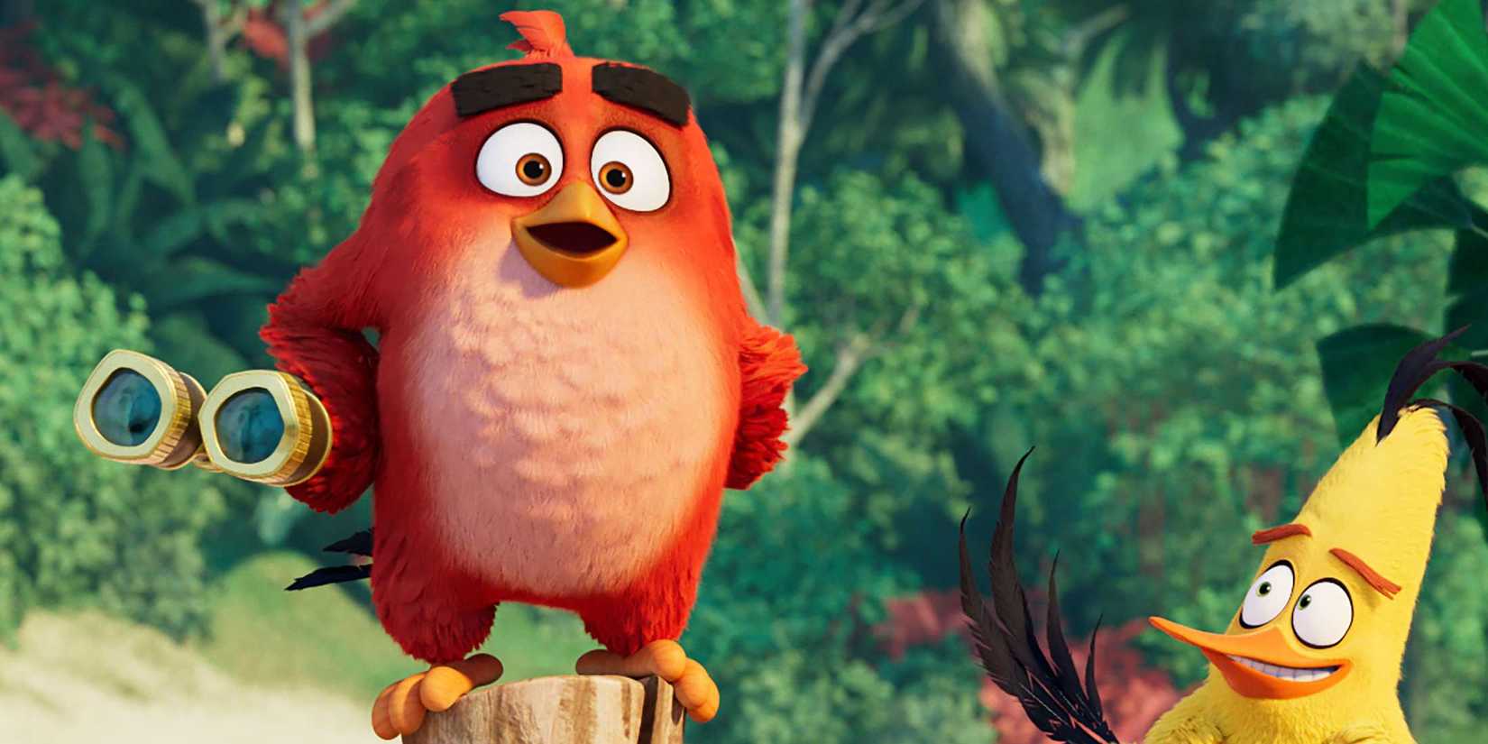 Red stands holding binoculars with Chuck in The Angry Birds Movie 2.