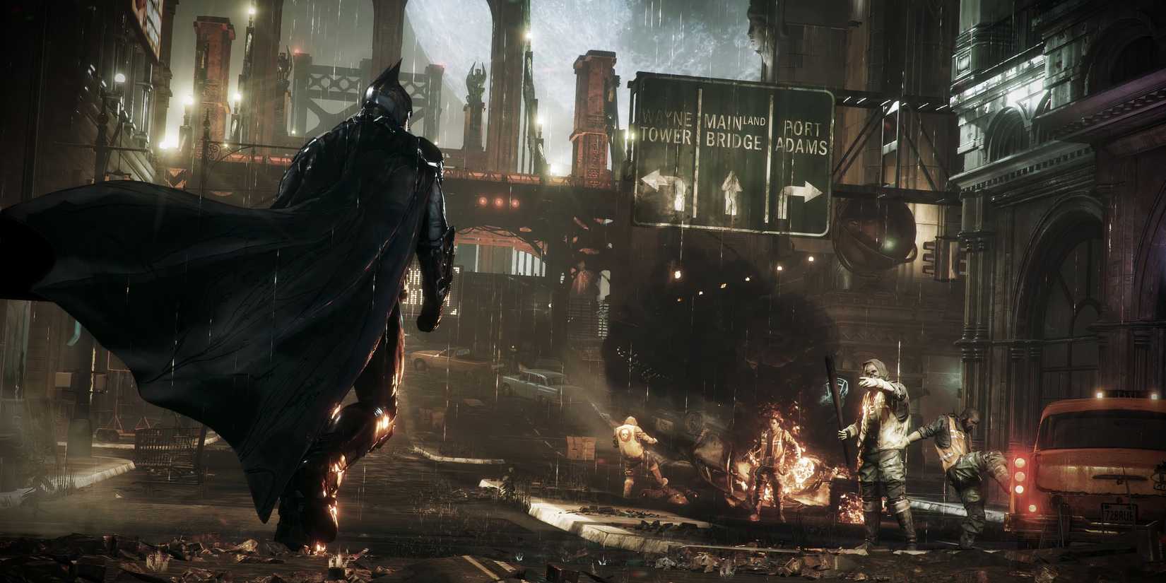 Batman walks through a burning Gotham in Batman: Arkham Knight.