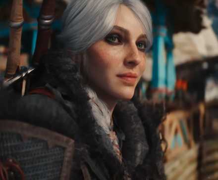 Ciri smiling in The Witcher 4. She has white hair and green eyes. She is wearing dark clothes and dark makeup around her eyes.