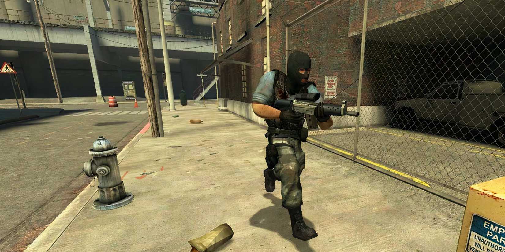 Balaclava-wearing man running throuhg a litter-filled street holding a gun in counter-strike:source.