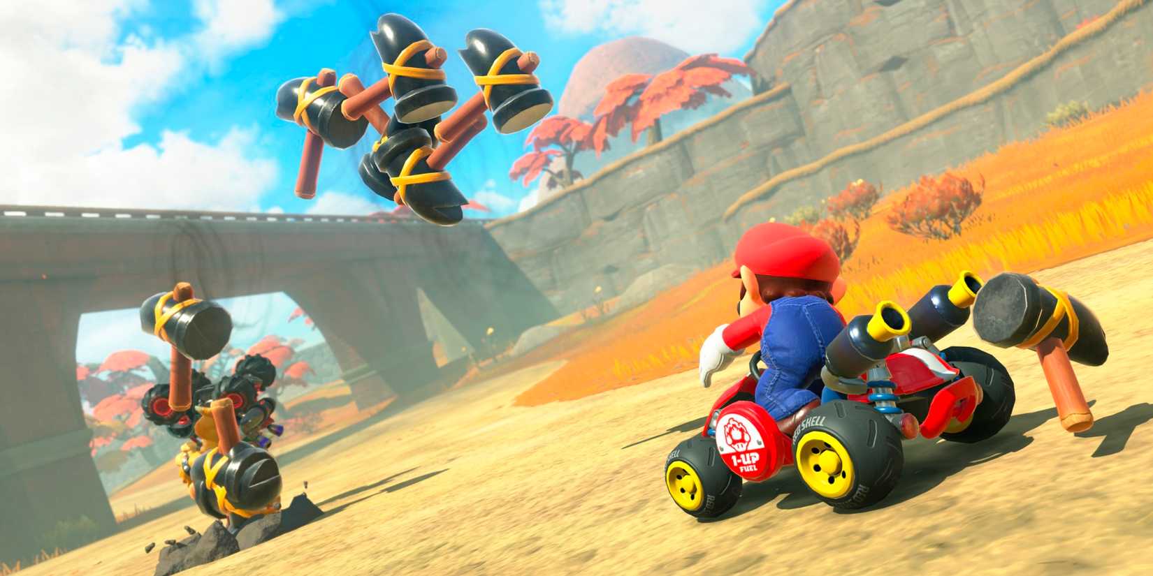 Mario using the Hammer item on Bowser in Mario Kart World.