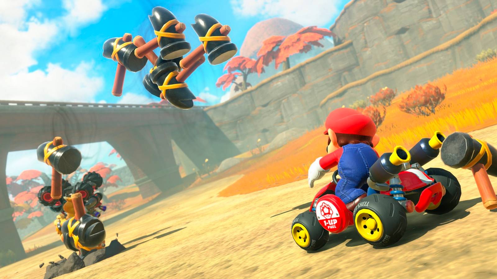 Mario using the Hammer item on Bowser in Mario Kart World.