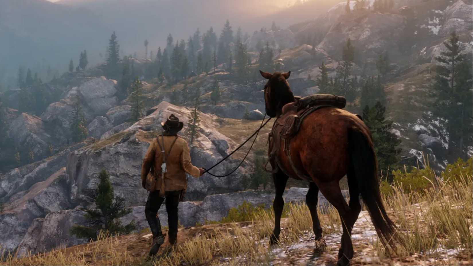 Arthur Morgan walking his horse through the mountain ranges in Red Dead Redemption 2.