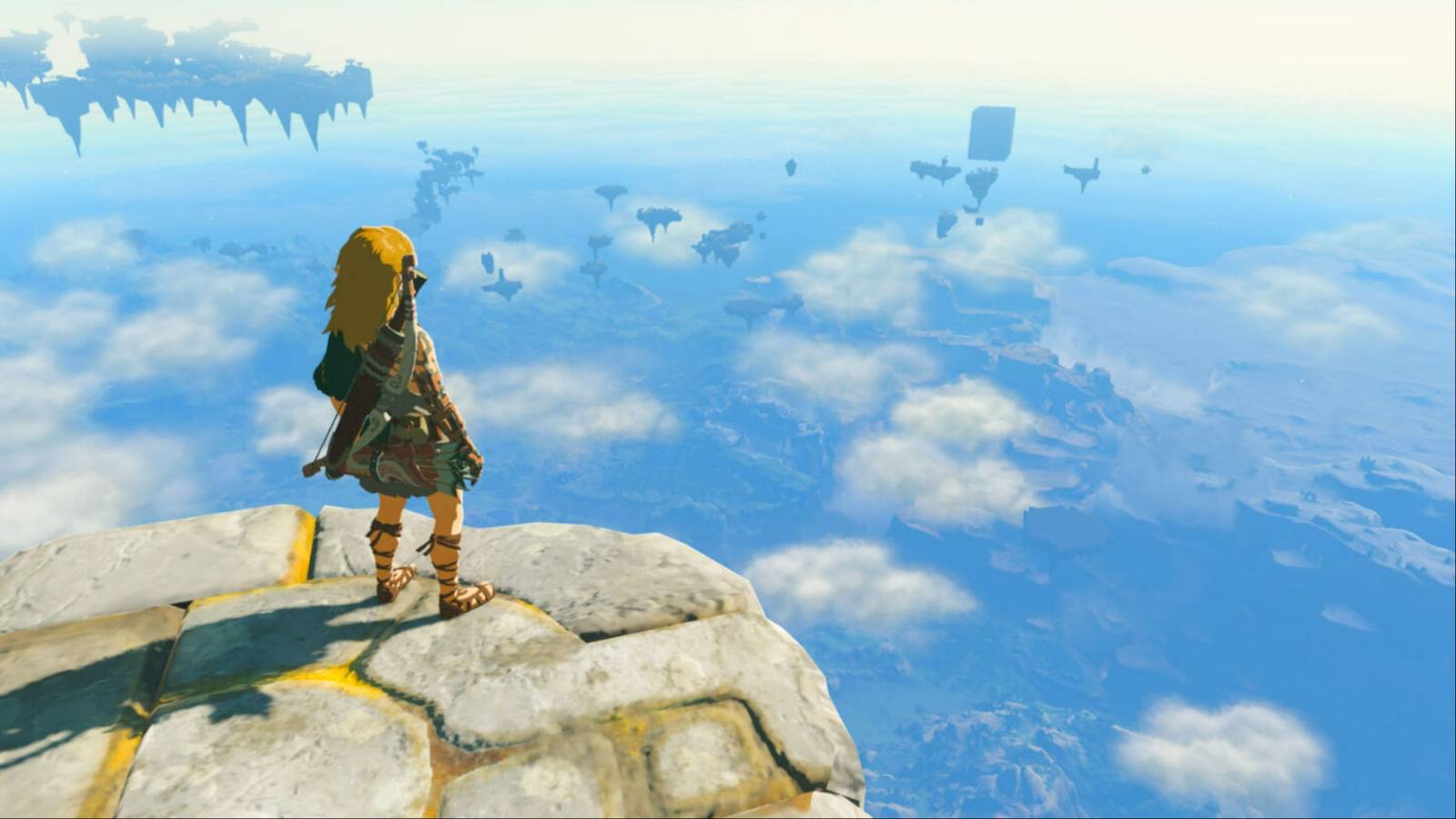 Link looking down at the destroyed Hyrule beneath him, as he stands atop a sky island in The Legend of Zelda: Tears of the Kingdom.