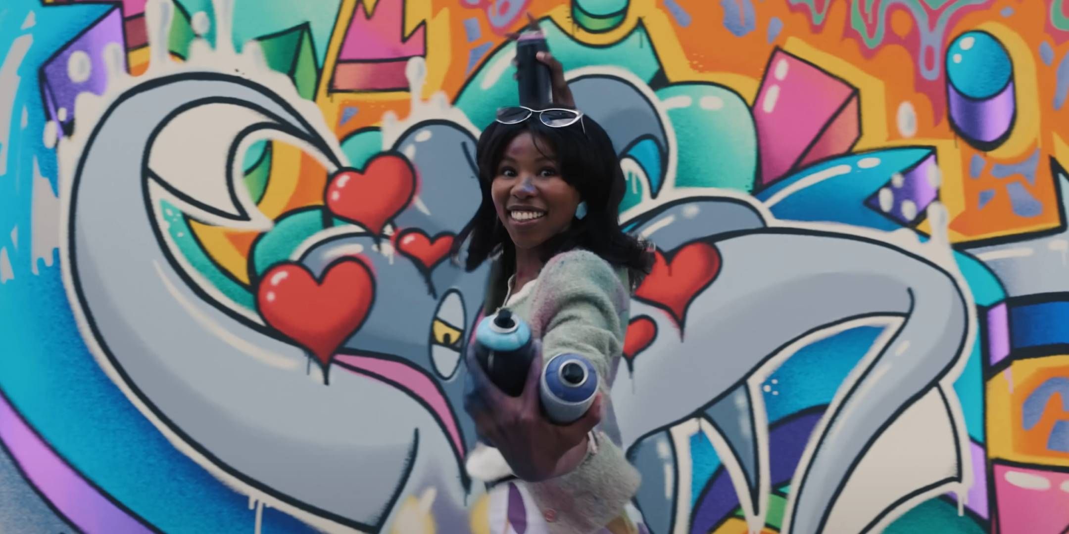 An excited woman reveals a Malamar graffiti project.