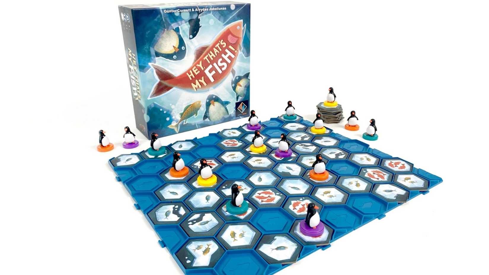 A board game laid out with penguins and pieces.