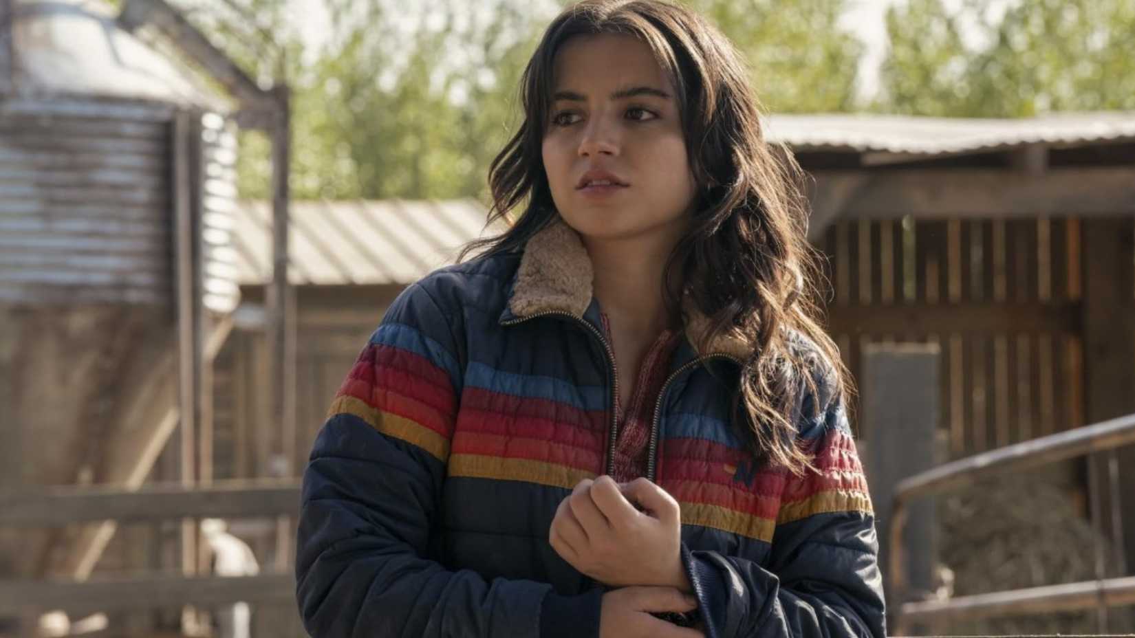 Isabela Merced as Dina wearing the rainbow-striped jacket in The Last of Us Season 2.