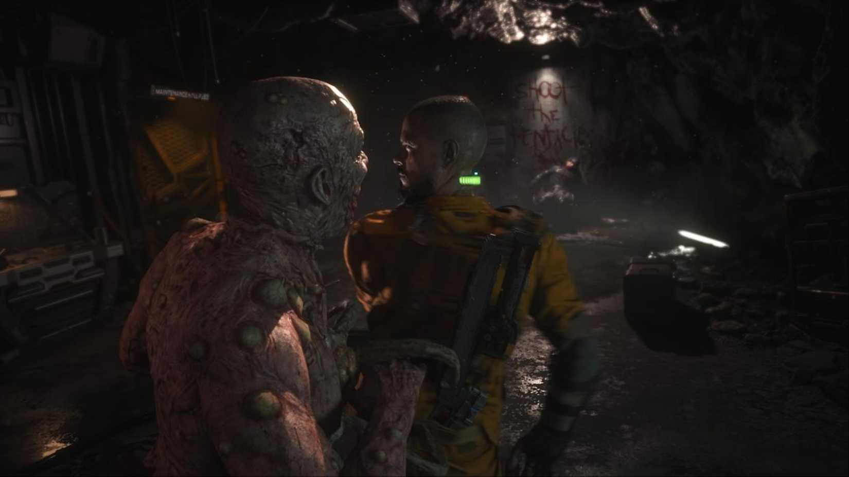 A Grunt Biophage sneaking up on Jacob Lee in a dimly lit room in The Callisto Protocol.