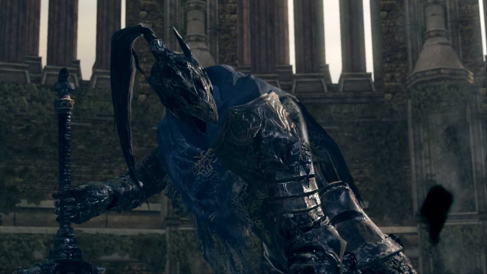 Knight Artorias, the Abysswalker, planting his sword in the ground, preparing himself for combat, in Dark Souls Remastered.