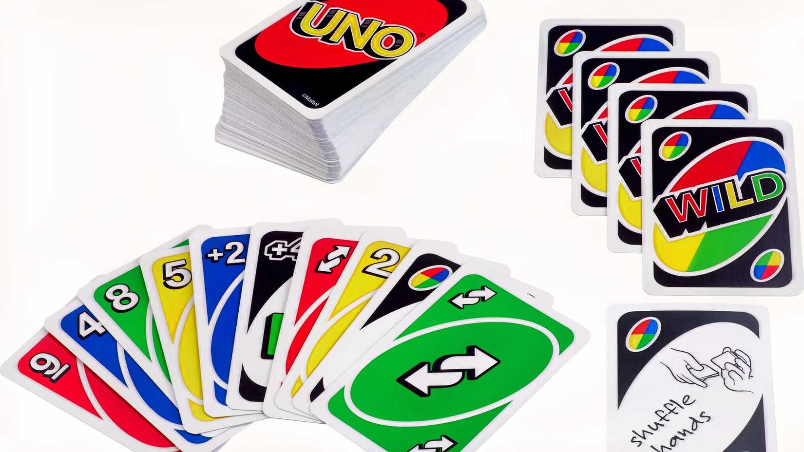 Several uno cards laid on the table next to an uno deck.