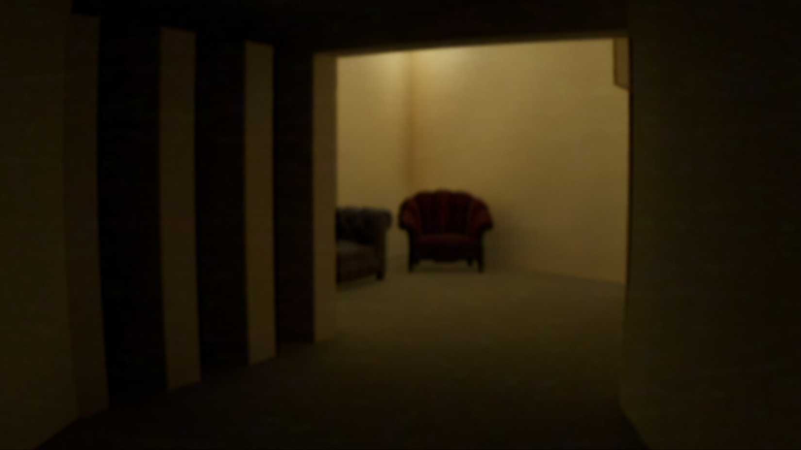 An eerie, dim room with two chairs in The Complex: Found Footage.