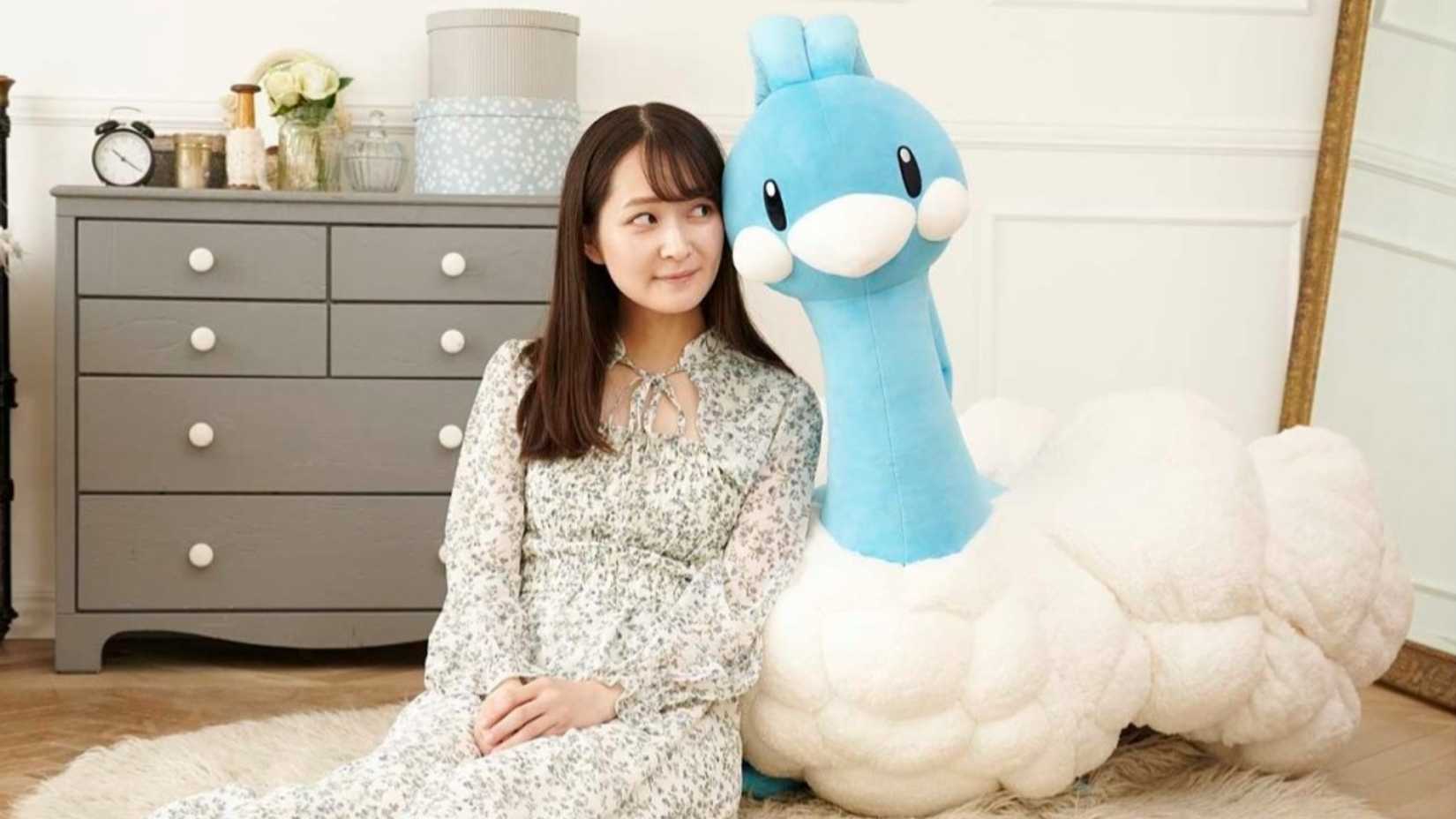 woman with life size altaria plush.