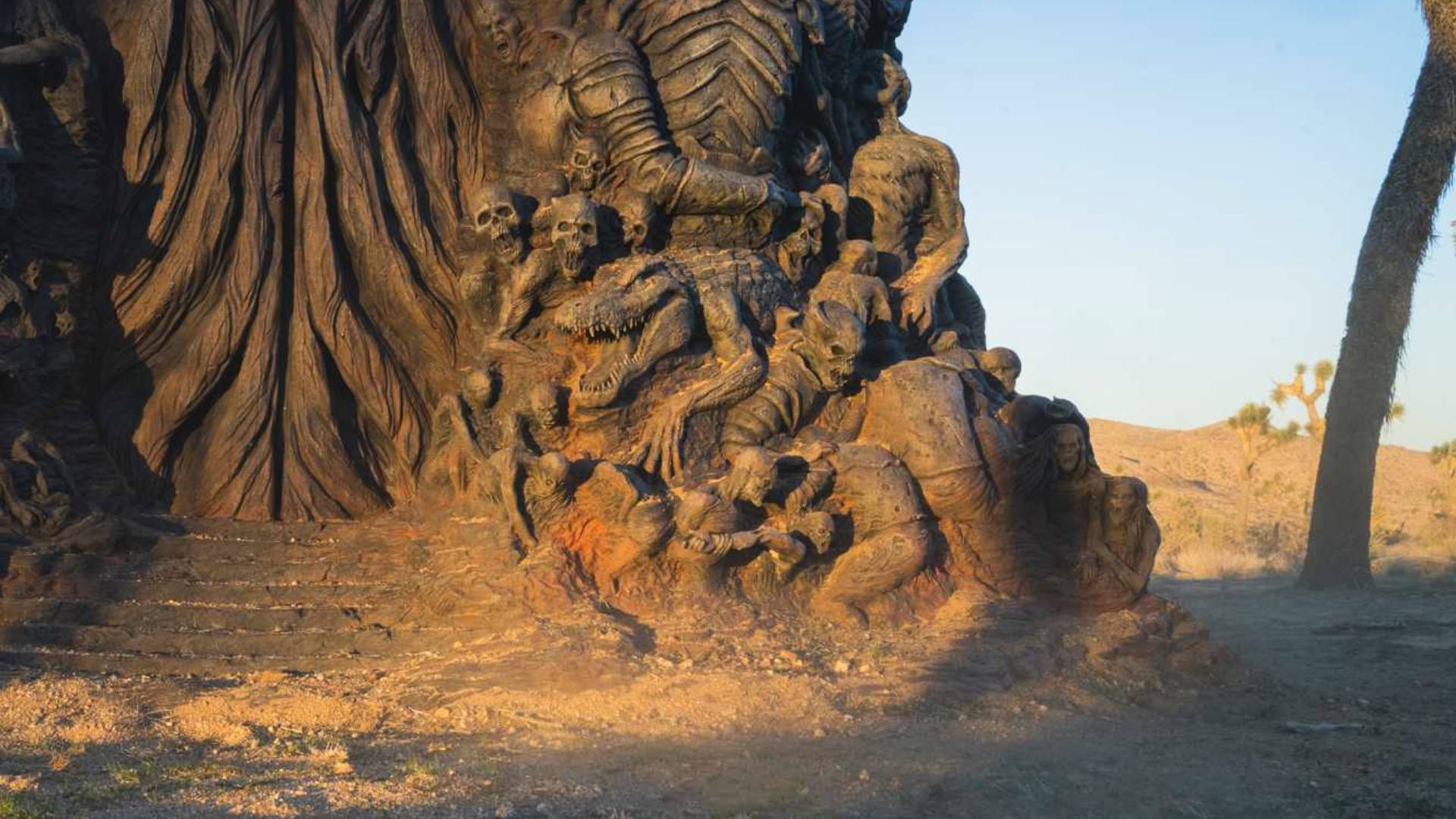 A dusty statue in the middle of the desert.