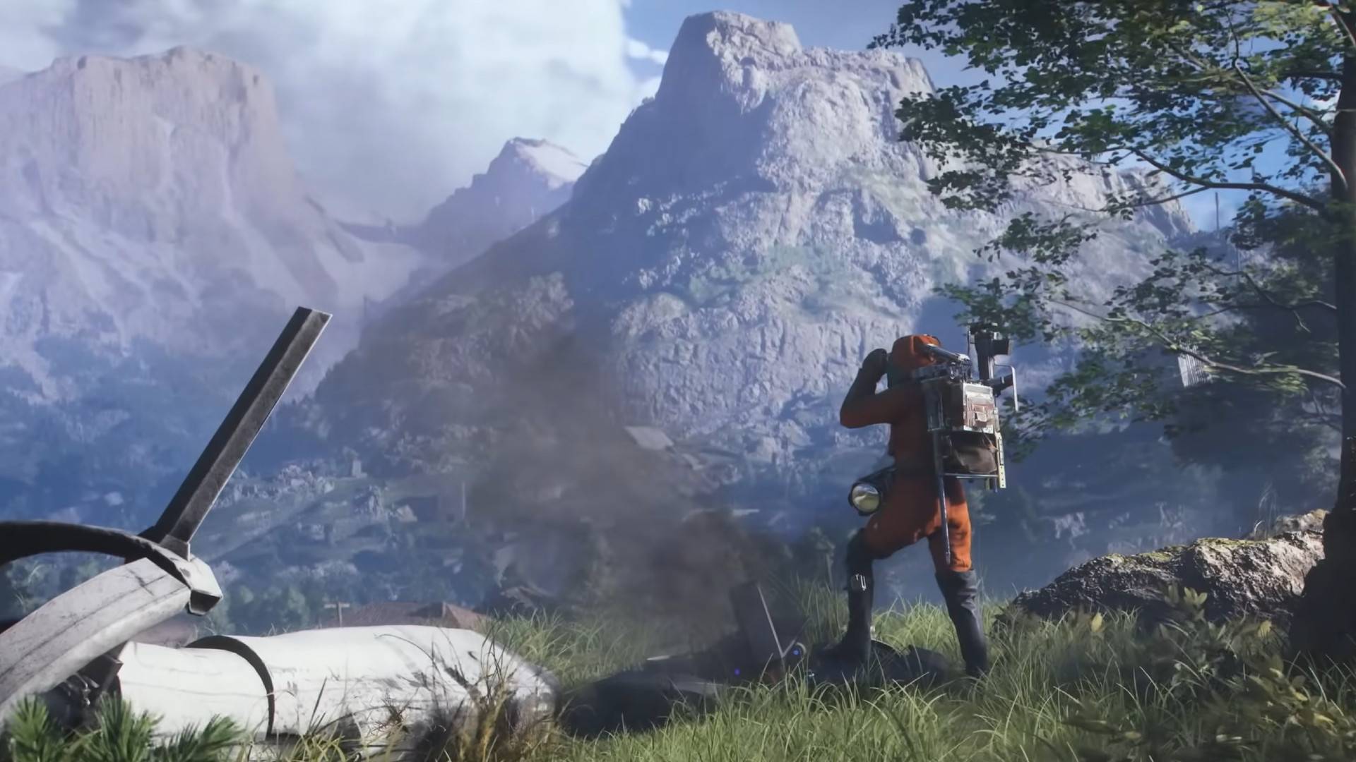 A person in an ornage suit looking out over a valley.