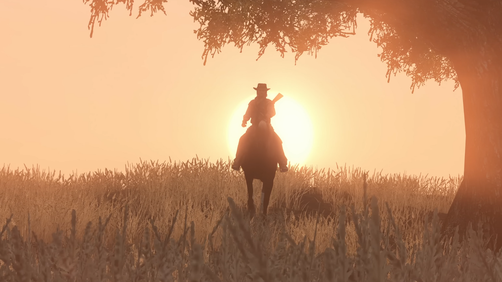 Silhouette of a cowboy riding a horse in front of a sunset in Red Dead Redemption.