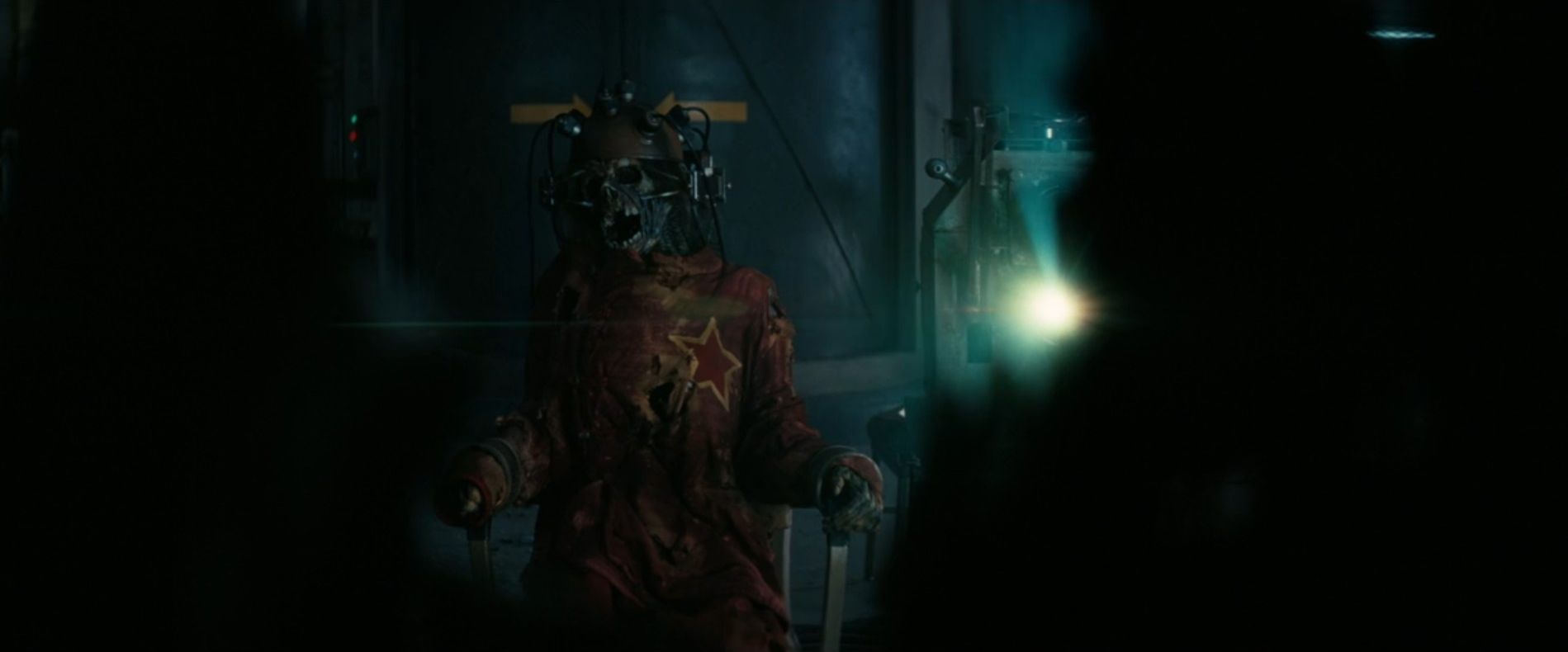 Skeleton in a commjunist outfit hooked up to a machine.