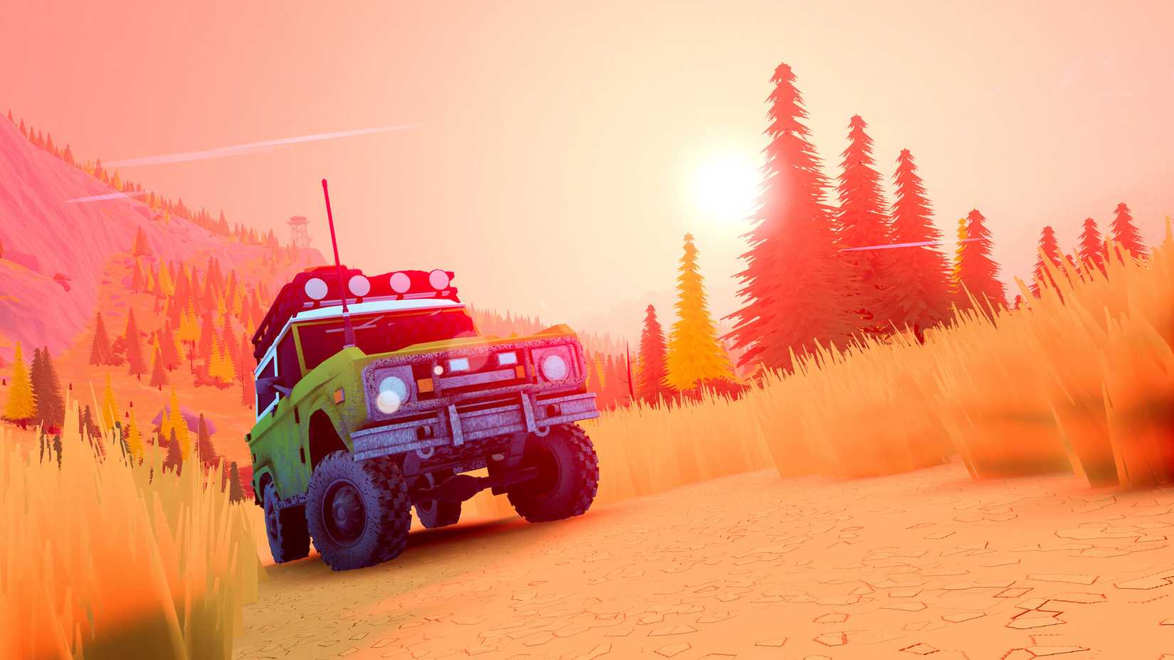 Jeep on hillside with sunset in background and trees.